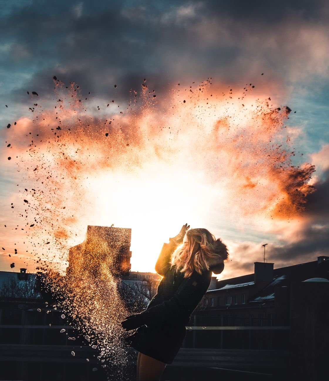 Silhouette of a woman against a dramatic sunset and splash — action genre
